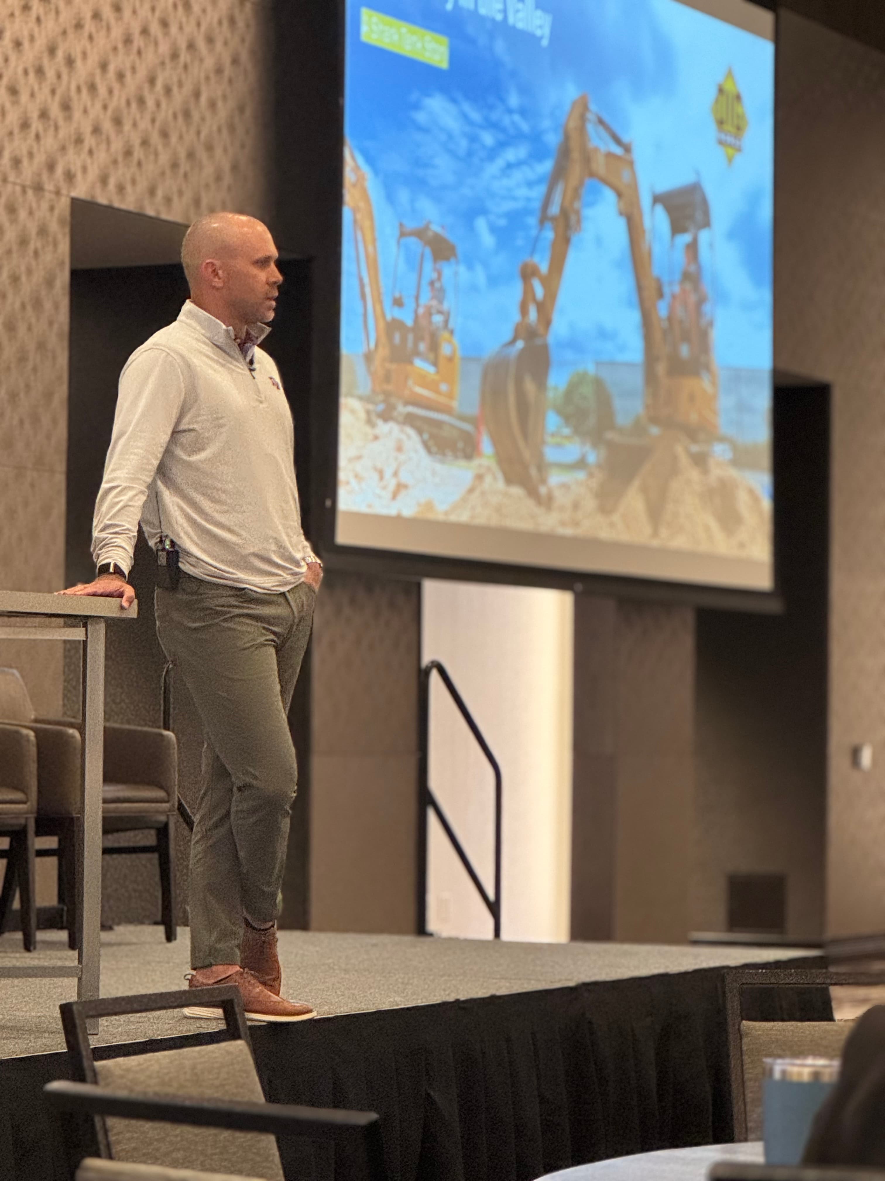 Jacob Robinson speaking on stage in front of an audience